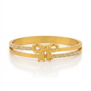 Gold bangle with bow centerpiece and sparkling crystal accents